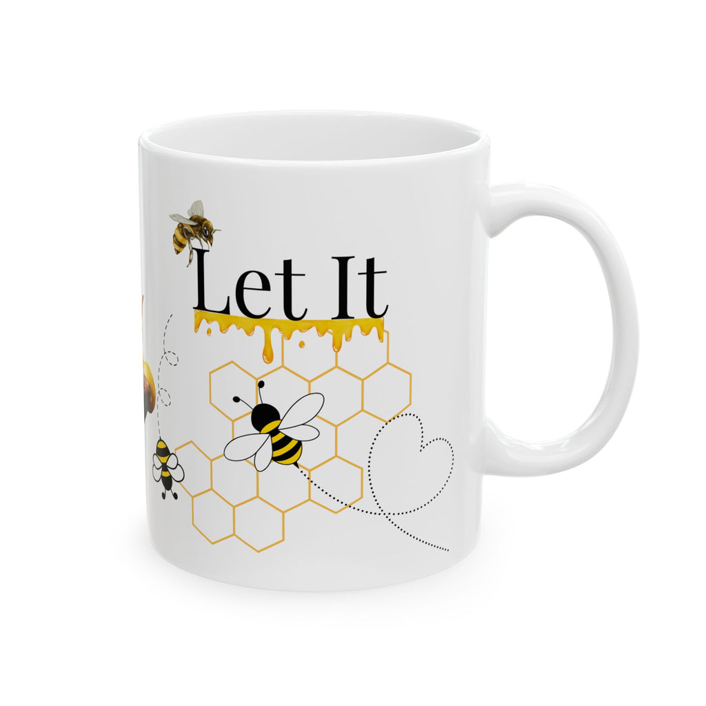 White ceramic coffee mug with “Let It” text, honeybee and honeycomb graphic