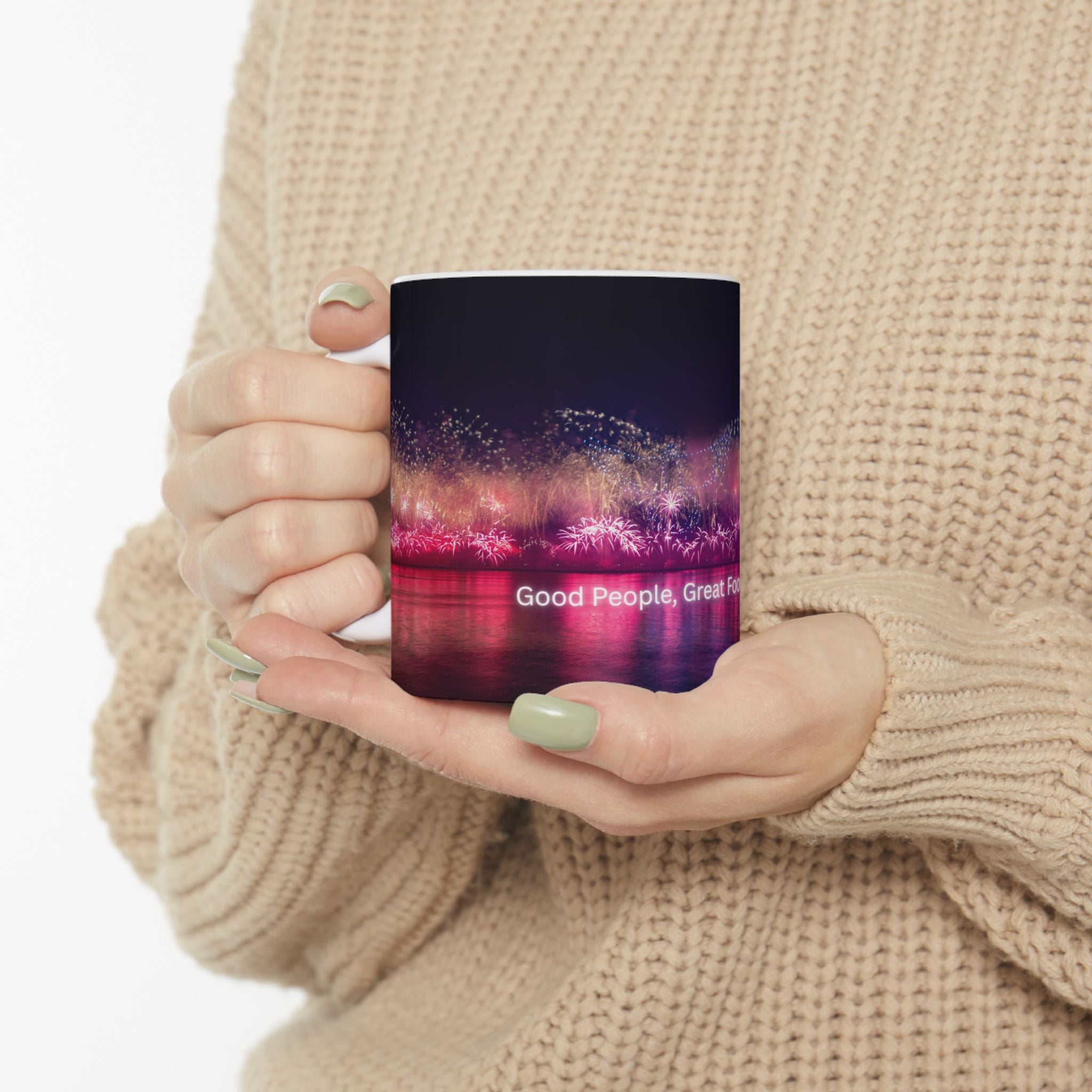 Ceramic mug with neon nightscape fireworks and partial quote on front, held by hand