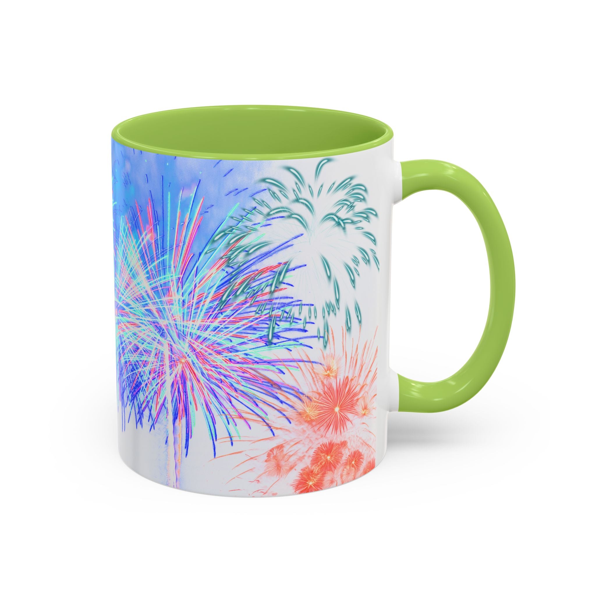 Ceramic coffee mug with green rim and handle; white body with colorful fireworks print.