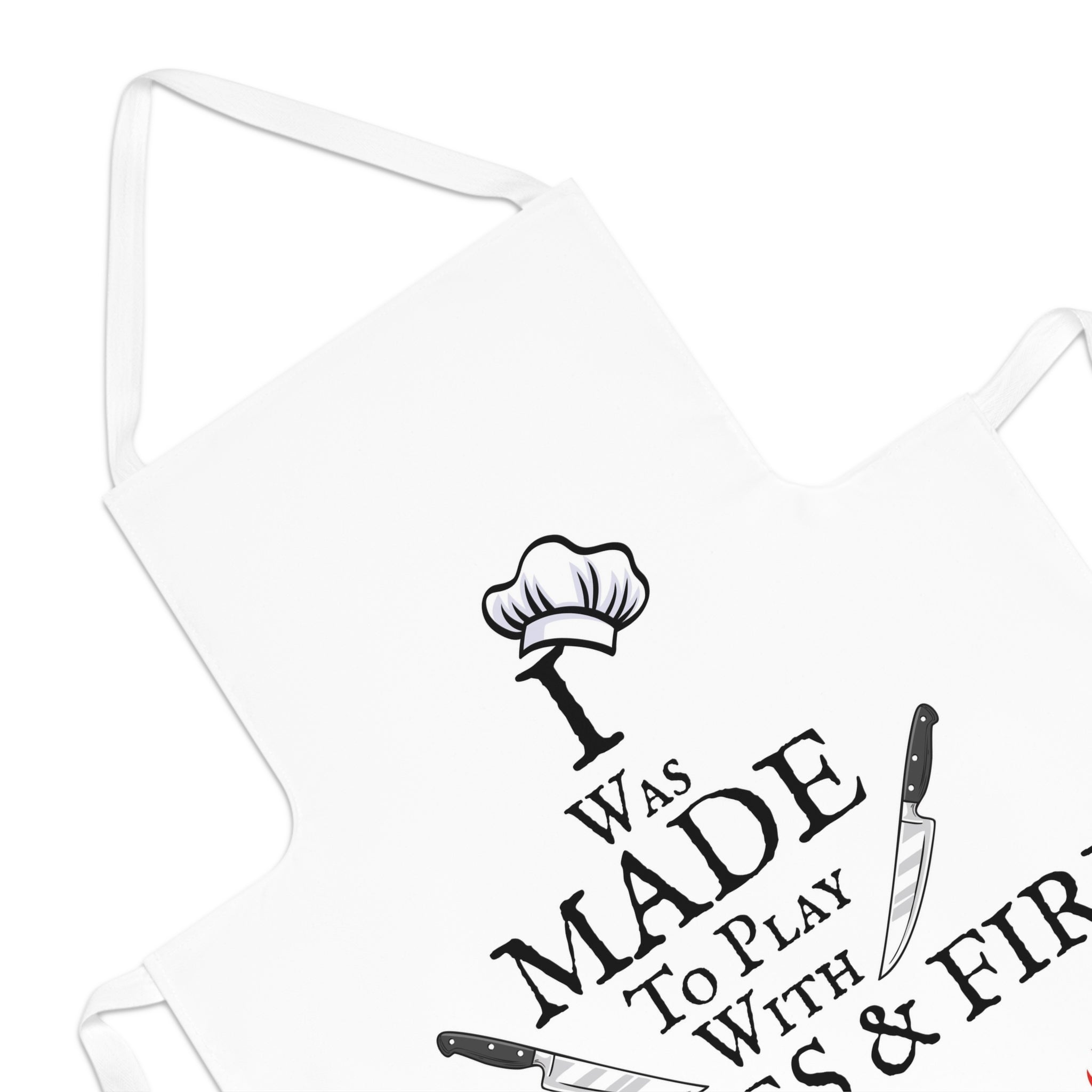 White apron close-up showing 'Was Made' text, chef hat icon, and crossed knives