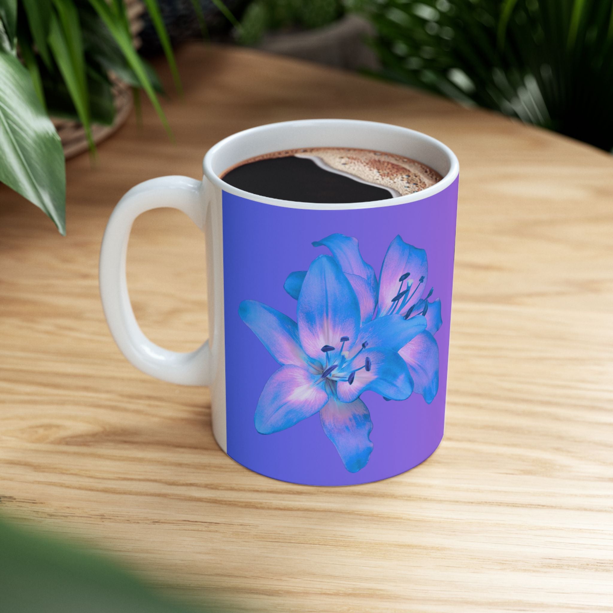 Ceramic coffee mug with blue flower print and Coffee style design, filled with coffee