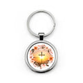 Stainless steel round keychain with split ring; circular pendant shows a cross at sunrise with flowers