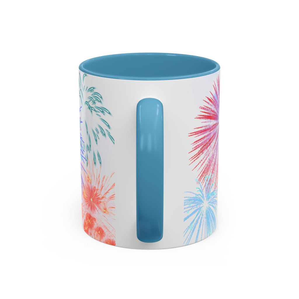 Ceramic coffee mug with light blue rim and handle; white design shows fireworks on sides.