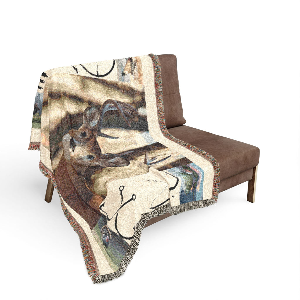 Deer hunting woven throw draped on chair with buck face and hunting symbol print