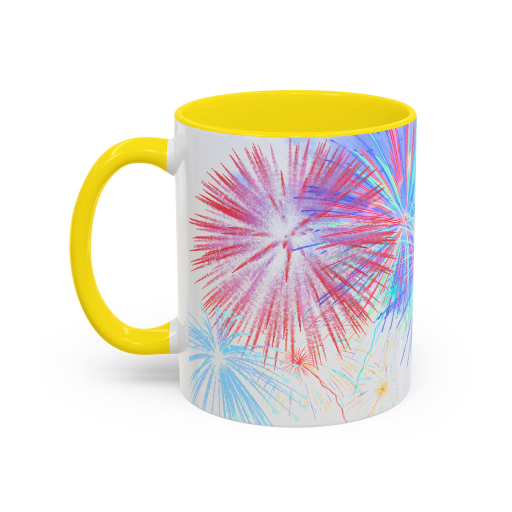 Ceramic coffee mug with yellow rim and handle; colorful fireworks burst print on white body.