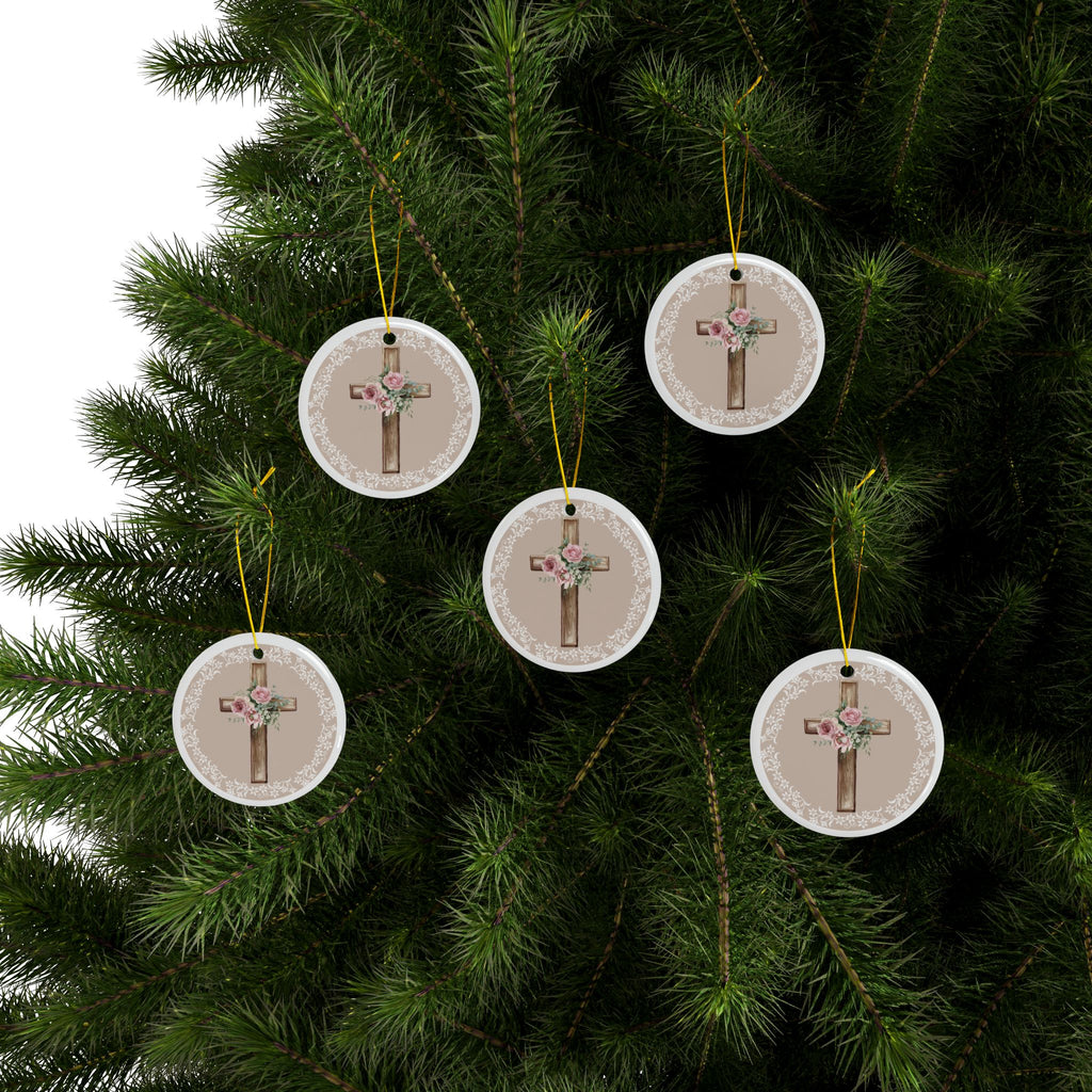 Set of round ceramic cross ornaments with floral bouquet on wood cross, hanging on a tree