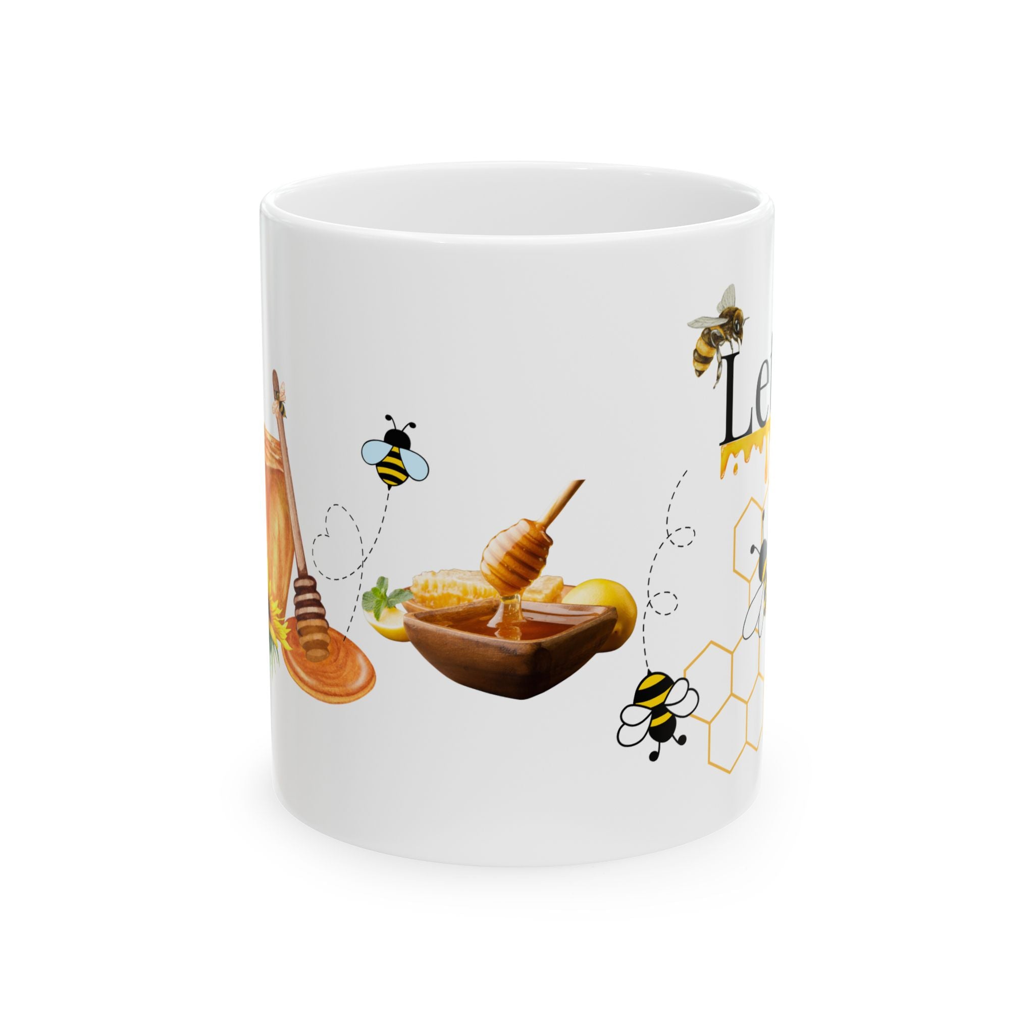 White ceramic coffee mug with honeycomb and bee, plus honey dipper and honey bowl