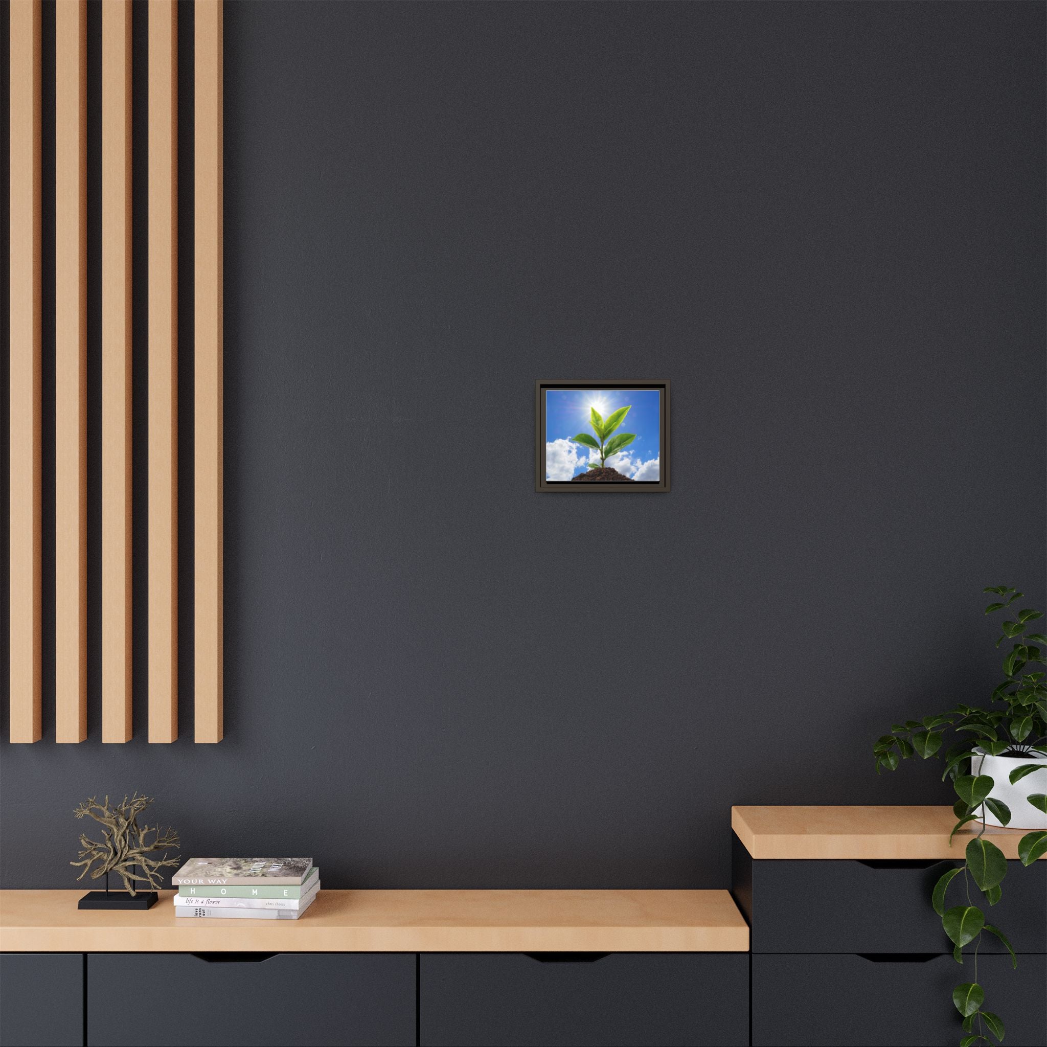 Framed sprouting plant canvas wall art with green leaves in a dark frame