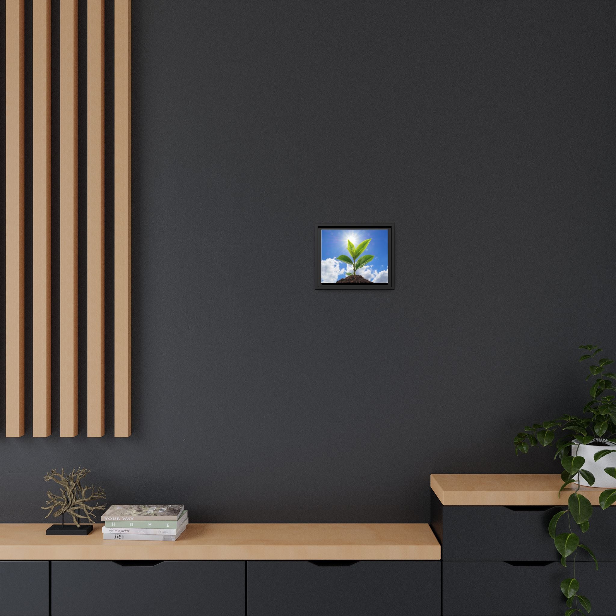 Framed sprouting plant canvas wall art featuring green leaves in a dark frame
