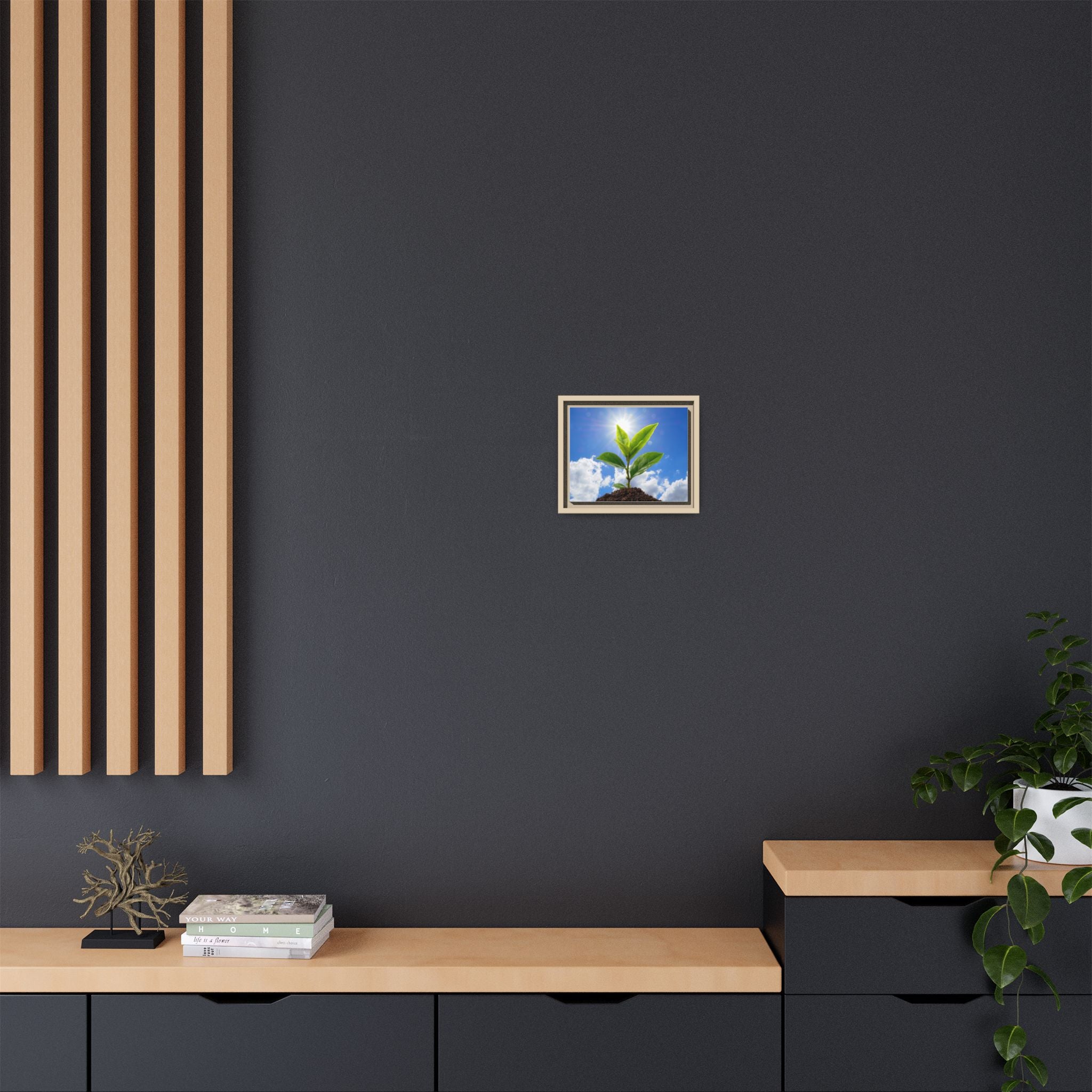 Framed sprouting plant canvas wall art with green leaves in a dark frame