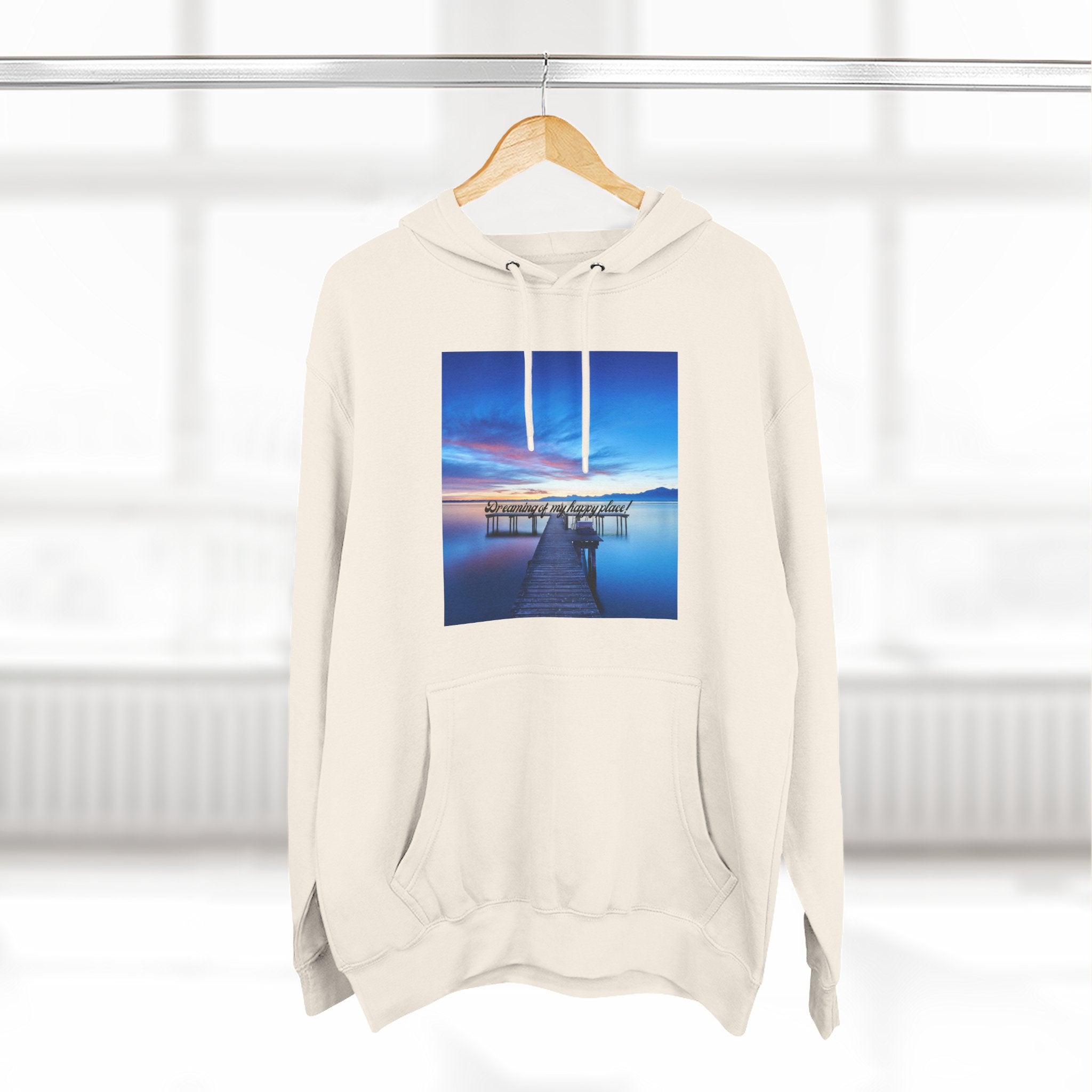 Light cream hoodie with centered dock photo graphic; drawstring hood and kangaroo pocket.
