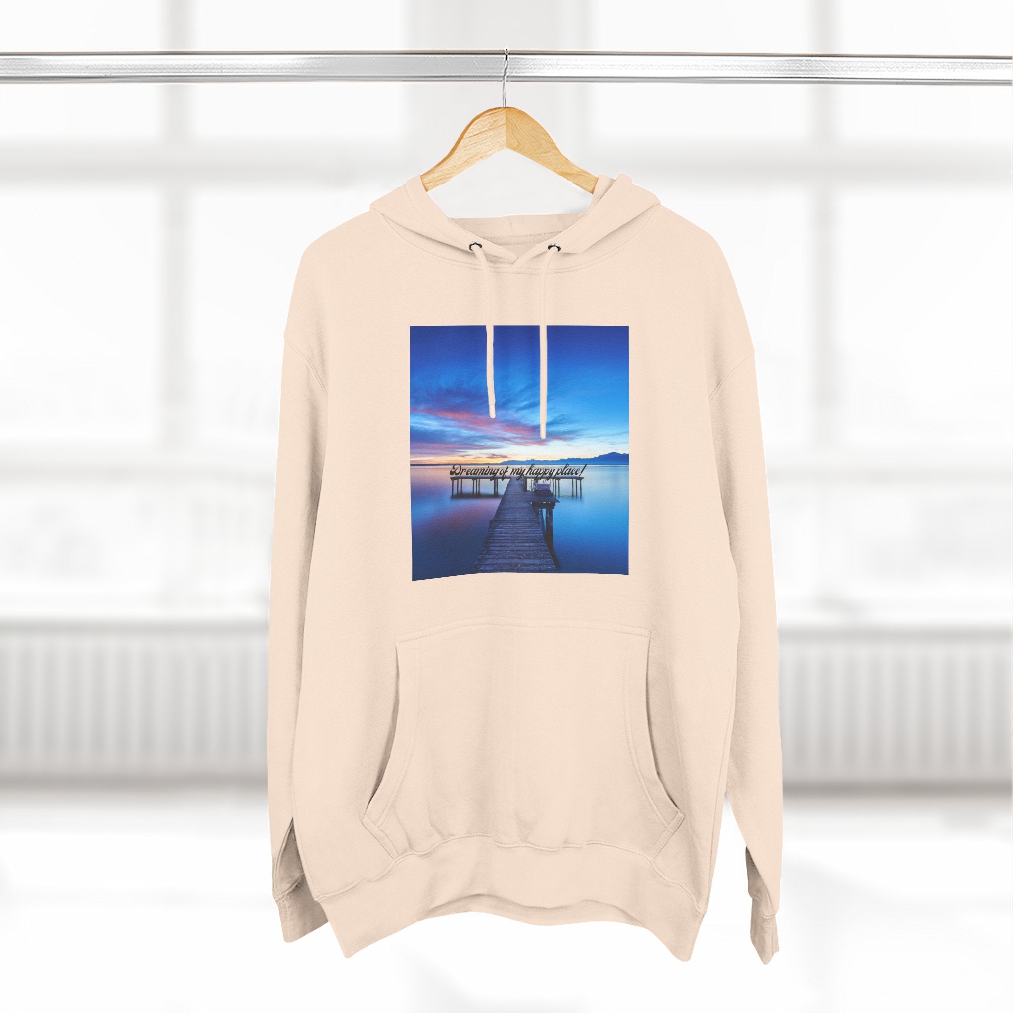 Light cream hoodie pullover with centered dock photo graphic; drawstring hood and front pocket.