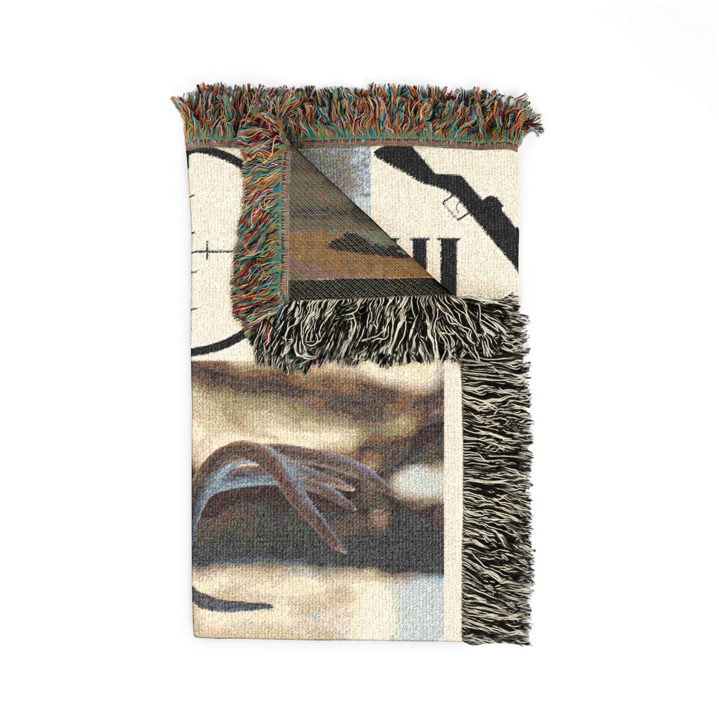 Corner view of deer hunting woven blanket with hunting graphic and fringe edge