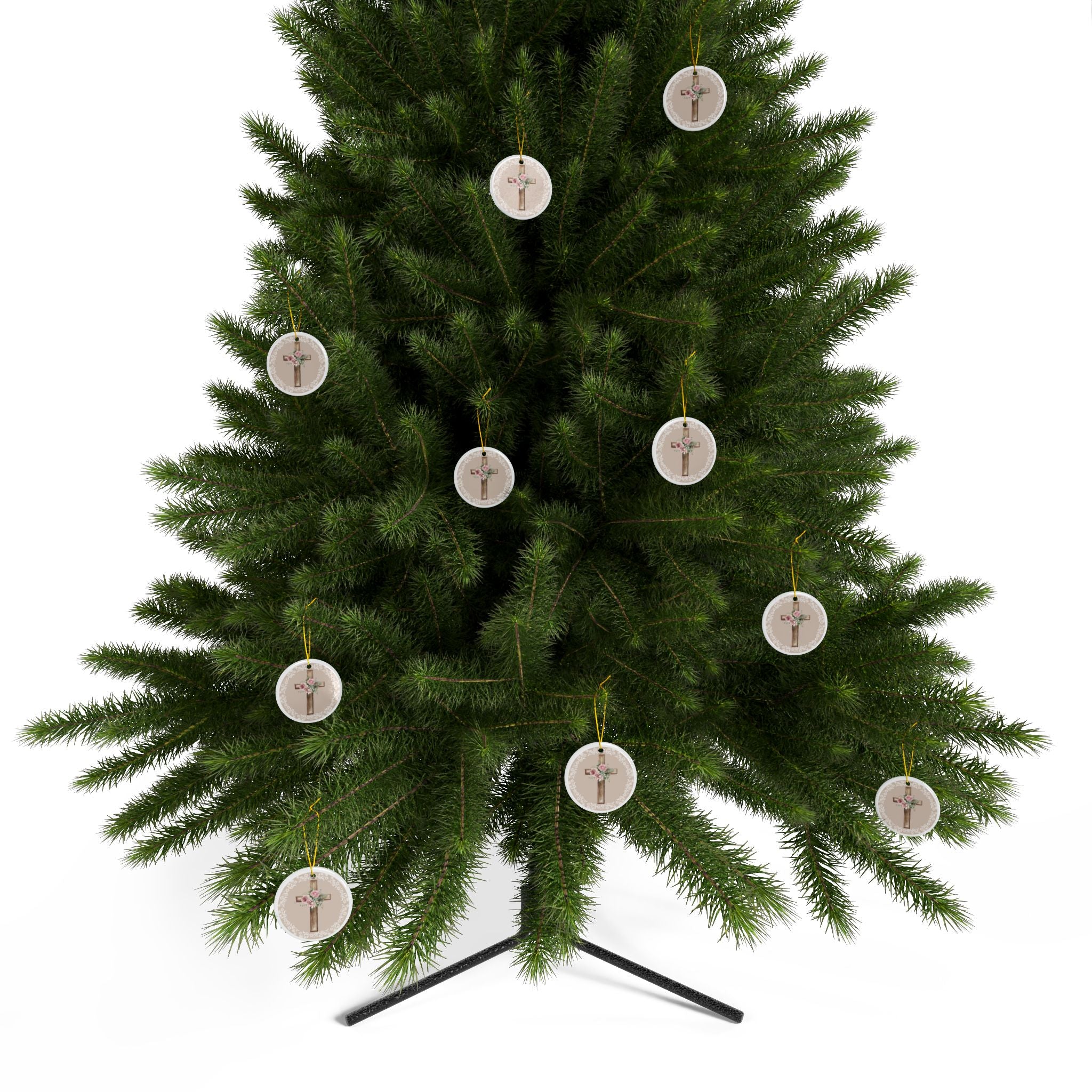 Round ceramic cross ornaments with floral bouquet on wood cross hanging from a tree