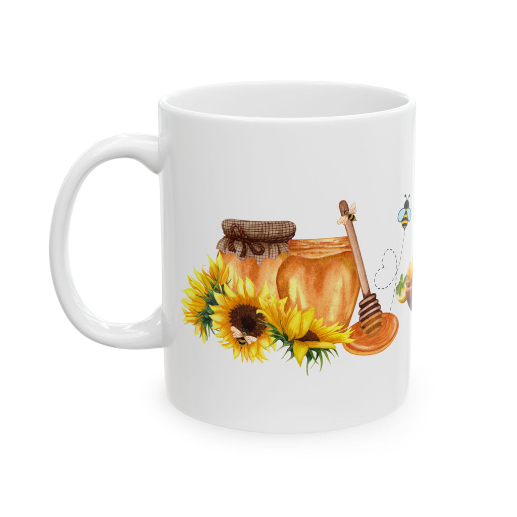 White ceramic coffee mug with honey jar, honey dipper, sunflower and bee illustrations